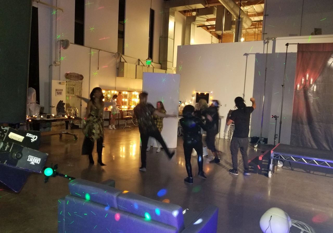 A Hollywood studio wrap party dj with a Halloween theme being it was late October and the set up crew testing the dance floor before party officially starts.